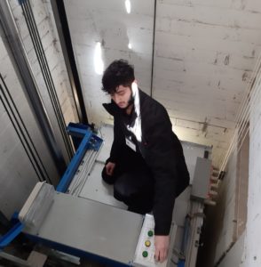 Trainee lift engineer in action