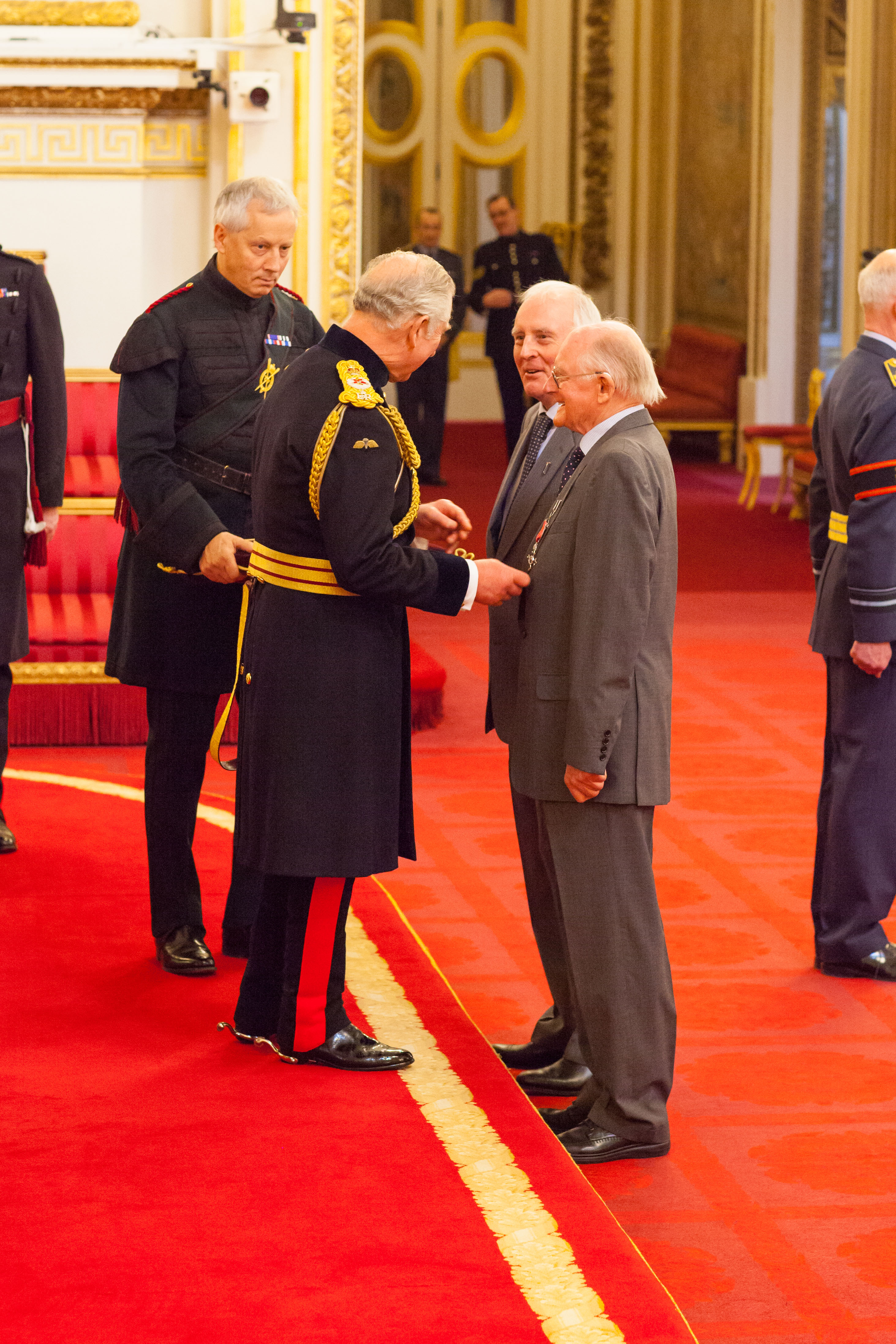 Mr. Alan Stannah and Mr. Brian Stannah are awarded their MBE (Member of the Order of the British Empire) medals by the Prince of Wales at Buckingham Palace.